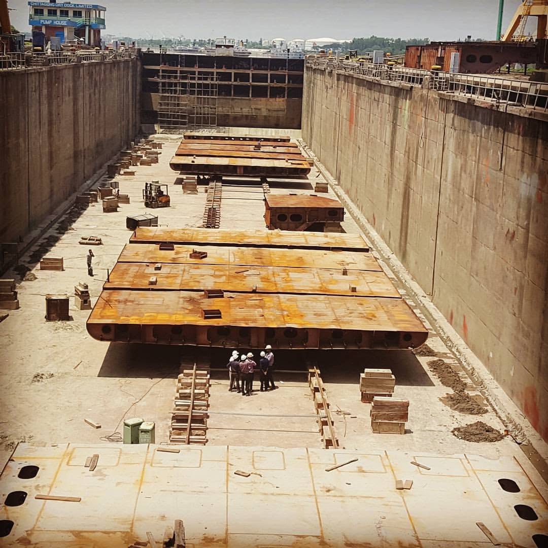 Barge and tanker sections under construction in a dry dock