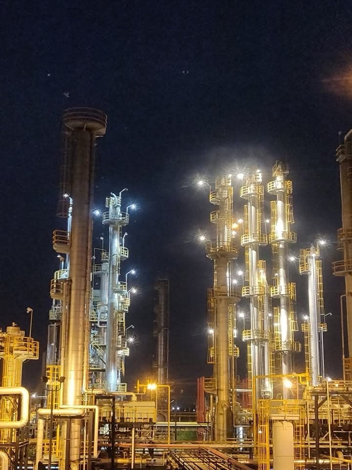 Petrochemical distillation columns lit at night